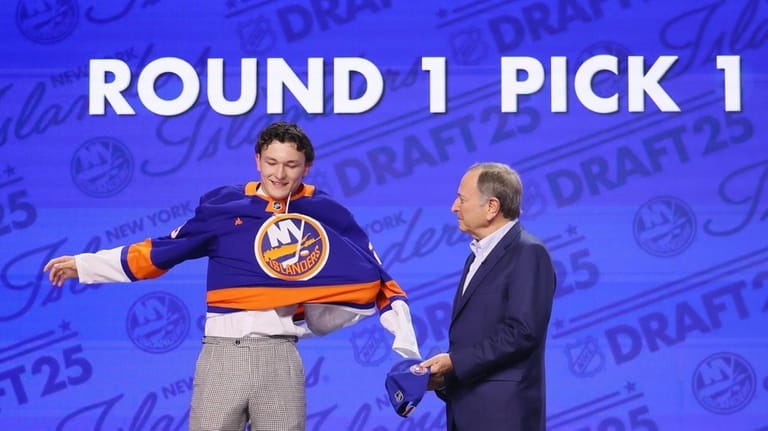 Matthew Schaefer puts on an Islanders sweater as NHL commissioner...