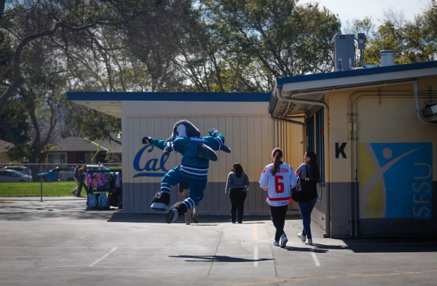 San Jose Sharks mascot S.J. Sharkie does a heal click while walking to a classroom at Bachrodt Elementary in San Jose, Calif., on Thursday, March 5, 2026. (Shae Hammond/Bay Area News Group)