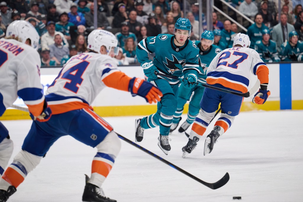 Jean-Gabriel Pageau (44) skates the puck up ice as Michael Misa (77) forechecks during the Islanders' 2-1 overtime win over the Sharks on March 7, 2026 in San Jose, Calif. 