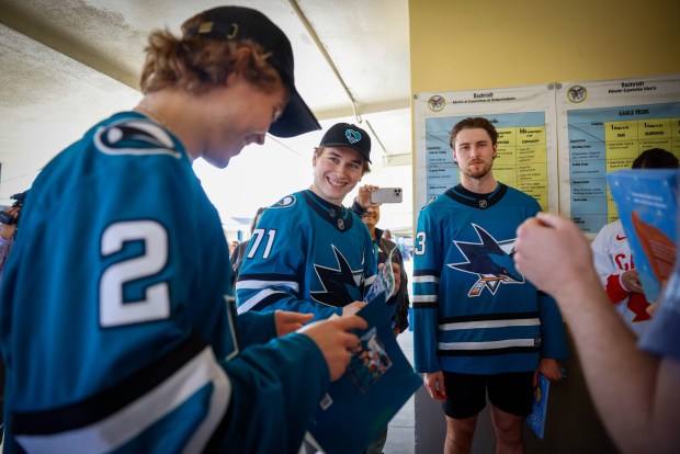 San Jose Sharks' Will Smith, Macklin Celebrini, and Zack Ostapchuk talk before reading to students at Bachrodt Elementary in San Jose, Calif., on Thursday, March 5, 2026. (Shae Hammond/Bay Area News Group)