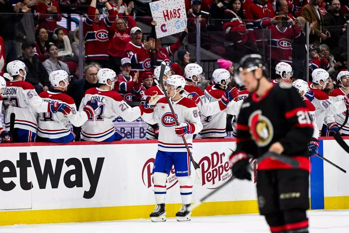 Montreal Canadiens' Alexandre Texier (85) celebrates his goal on Ottawa Senators' goaltender Linus Ullmark with teammates during the second period of an NHL hockey game in Ottawa, Ontario, Wednesday, March 11, 2026. (Spencer Colby/The Canadian Press via AP)