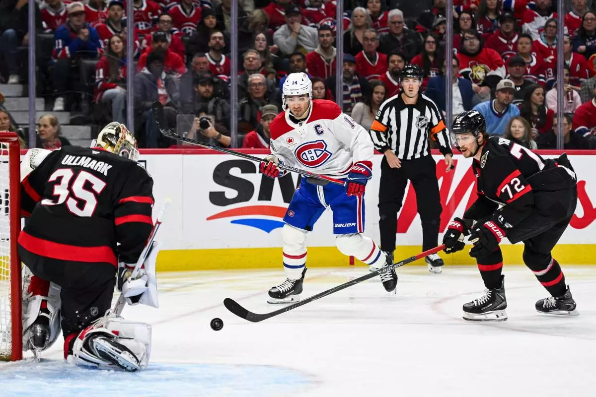 Montreal Canadiens' Nick Suzuki (14) looks for a rebound off of Ottawa Senators' goaltender Linus Ullmark (35) during the first period of an NHL hockey game in Ottawa, Wednesday, March 11, 2026. (Spencer Colby/The Canadian Press via AP)