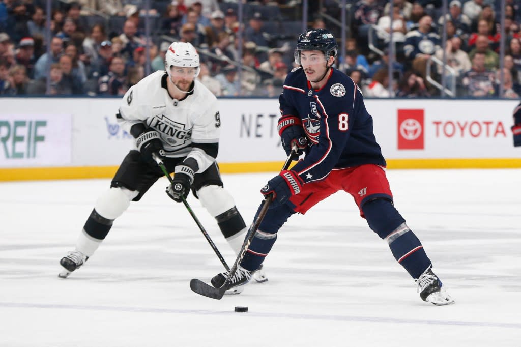 Blue Jackets defenseman Zach Werenski (8) controls the puck as Los Angeles Kings right wing Adrian Kempe (9) trails. IMAGN IMAGES via Reuters Connect