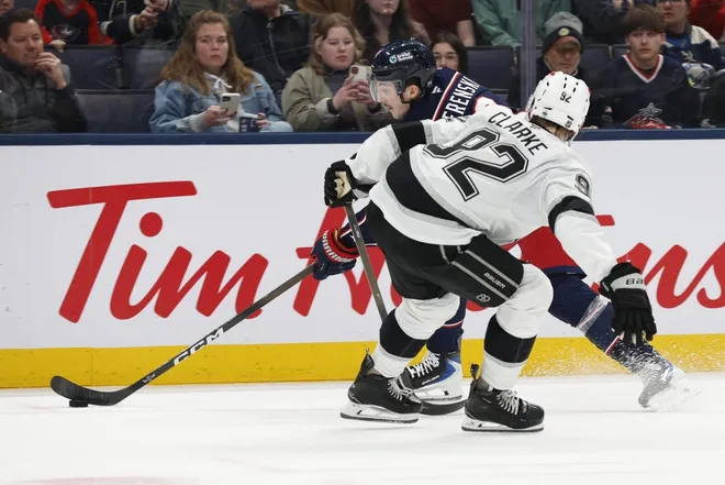 Mar 9, 2026; Columbus, Ohio, USA; Columbus Blue Jackets defenseman Zach Werenski (8) controls the puck past Los Angeles Kings right wing Taylor Ward (52) during the second period at Nationwide Arena.