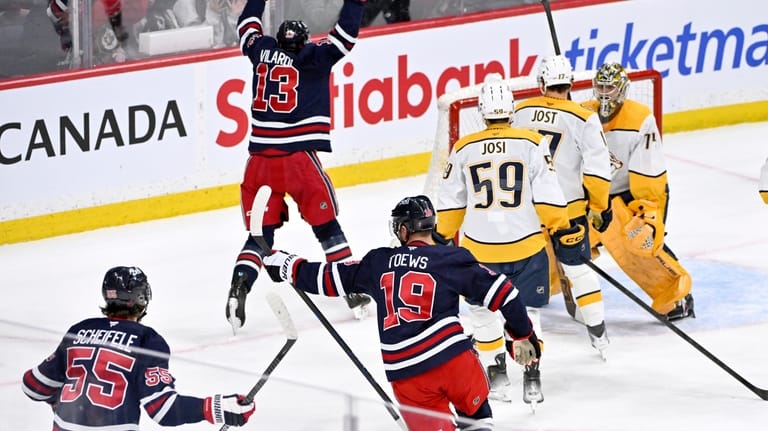Winnipeg Jets' Jonathan Toews (19) celebrates his goal on the...