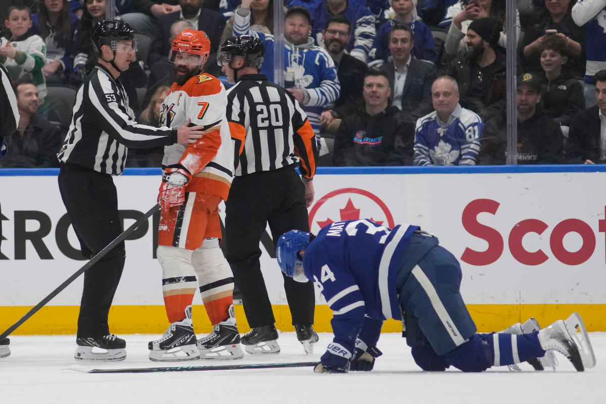Anaheim Ducks defenseman Radko Gudas (7) looks at an injured Toronto Maple Leafs forward Auston Matthews (34) after he delivered a knee-on-knee hit during the second period at Scotiabank Arena. Mandatory Credit: John E&period; Sokolowski-Imagn Images