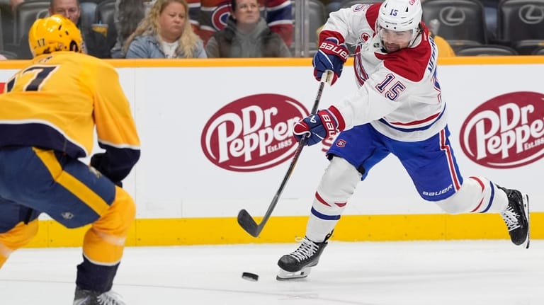 Montreal Canadiens center Alex Newhook (15) shoots the puck past...