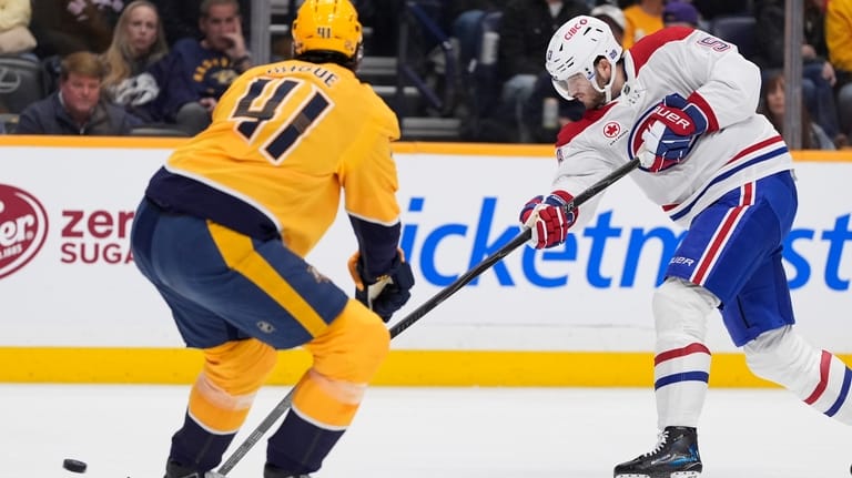 Montreal Canadiens defenseman Noah Dobson (53) shoots the puck past...