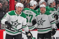 Dallas Stars' Mikko Rantanen, left, returns to the bench after scoring during the second...