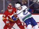 Vancouver Canucks' Zeev Buium battles with Calgary Flames' Blake Coleman on Saturday, March 28, 2026.