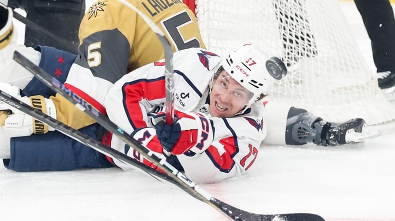 Washington Capitals center Dylan Strome (17) contests for a loose...