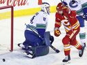 Calgary Flames' Joel Farabee celebrates his goal against Vancouver Canucks goalie Nikita Tolopilo in Calgary on Saturday, March 28, 2026.