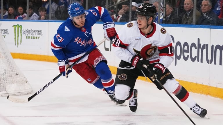 New York Rangers' Adam Fox (23) defends Ottawa Senators' Tim...