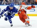 Maple Leafs captain Auston Matthews takes a knee-on-knee hit from Anaheim Ducks defenceman Radko Gudas in Toronto on March 12, 2026.