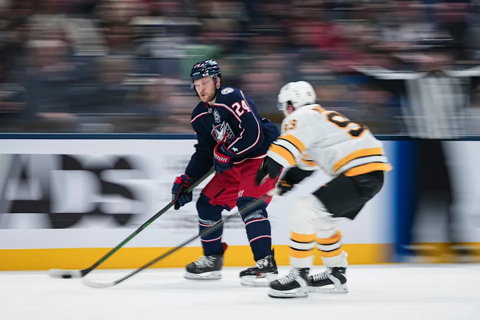 Columbus Blue Jackets right wing Mathieu Olivier (24) skates past Boston Bruins center Fraser Minten (93) during the first period of the NHL hockey game at Nationwide Arena on March 29, 2026.