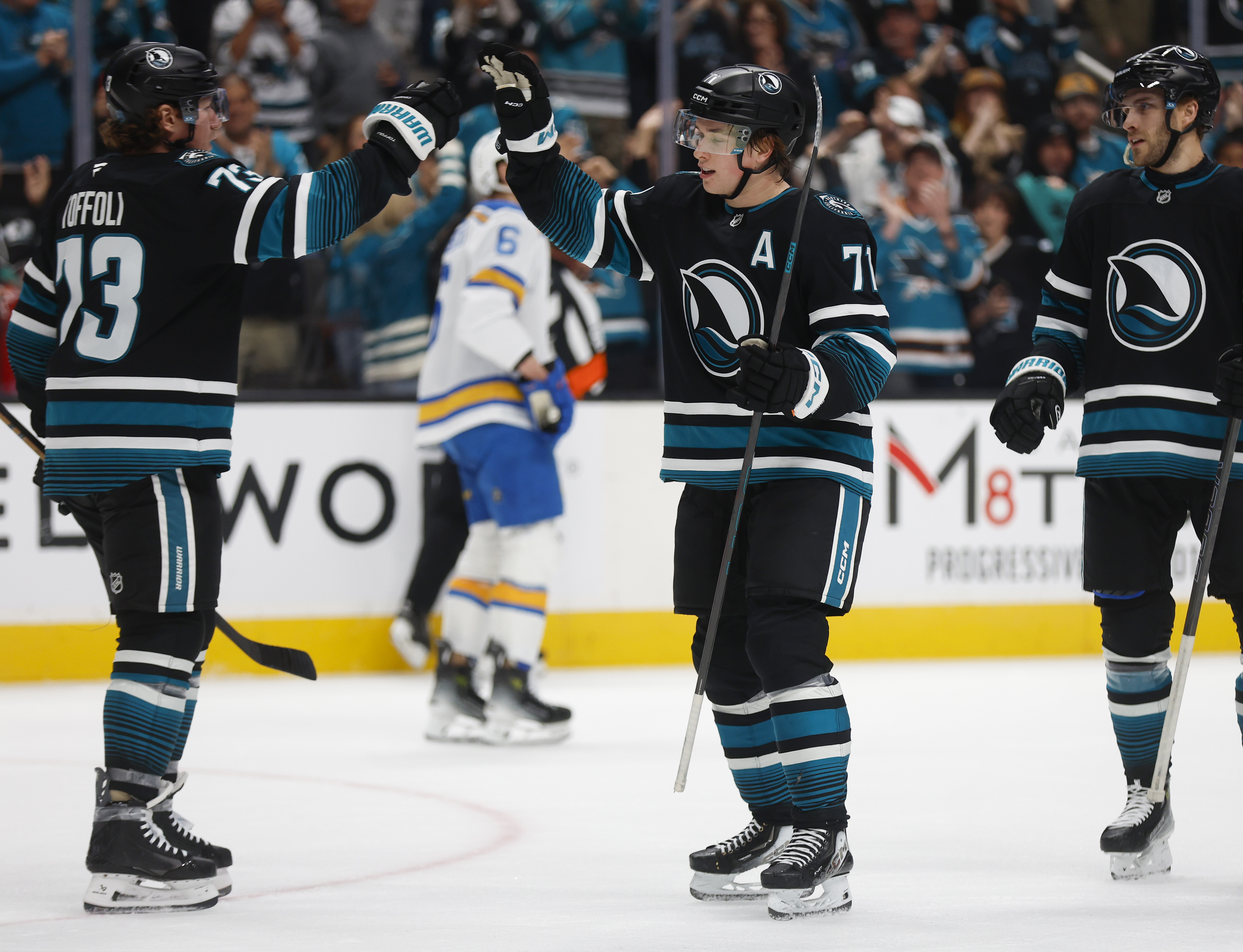 San Jose Sharks' Macklin Celebrini (71) high-fives San Jose Sharks'...