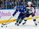 Zach Werenski of the Columbus Blue Jackets tries to keep Vancouver Canucks winger Evander Kane in check during Nov. 8 meeting at Rogers Arena.