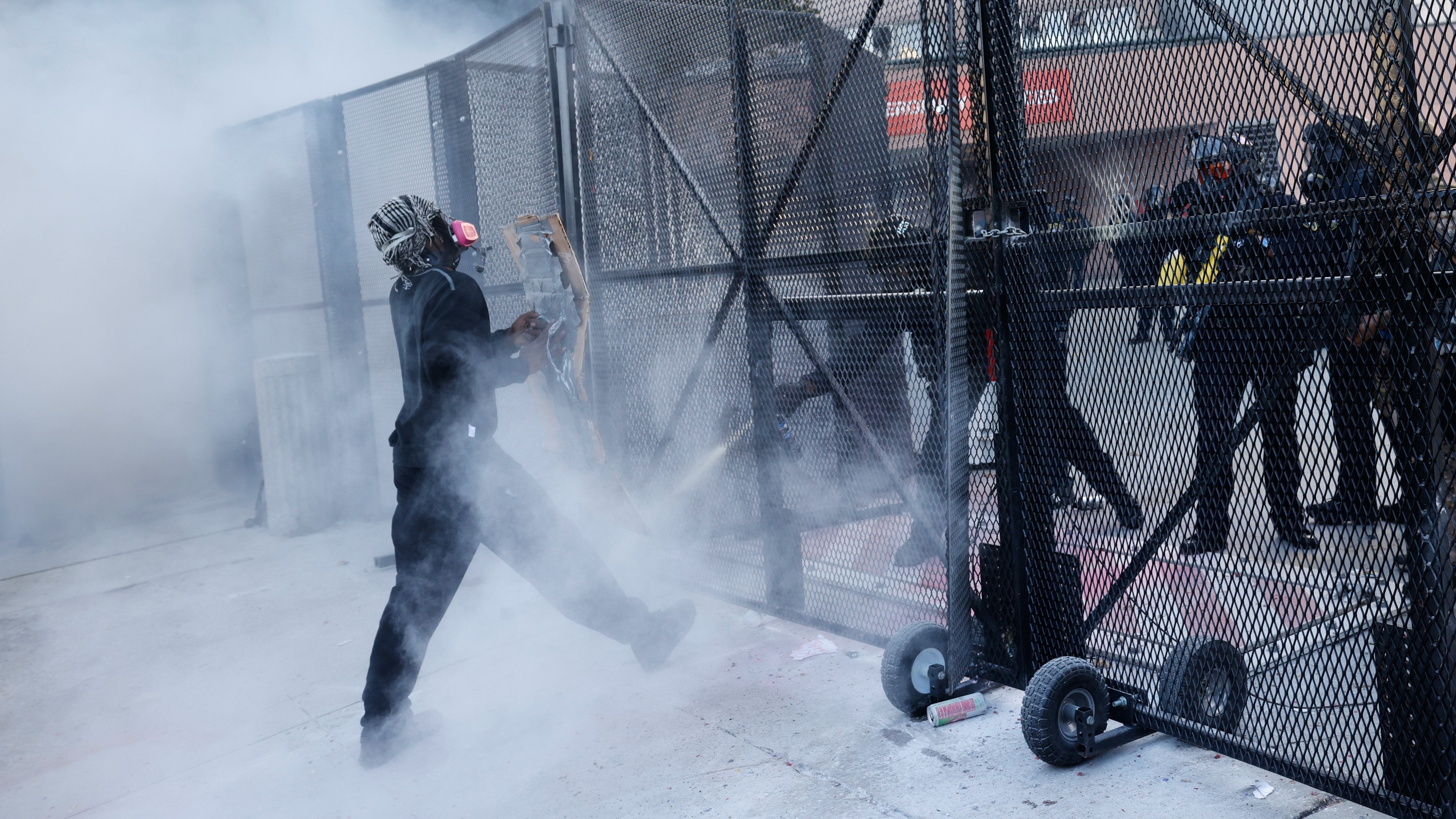 Police fire tear gas at a protestor outside the Metropolitan Detention Center in downtown Los Angeles during a "No Kings" rally Saturday, March 28, 2026.