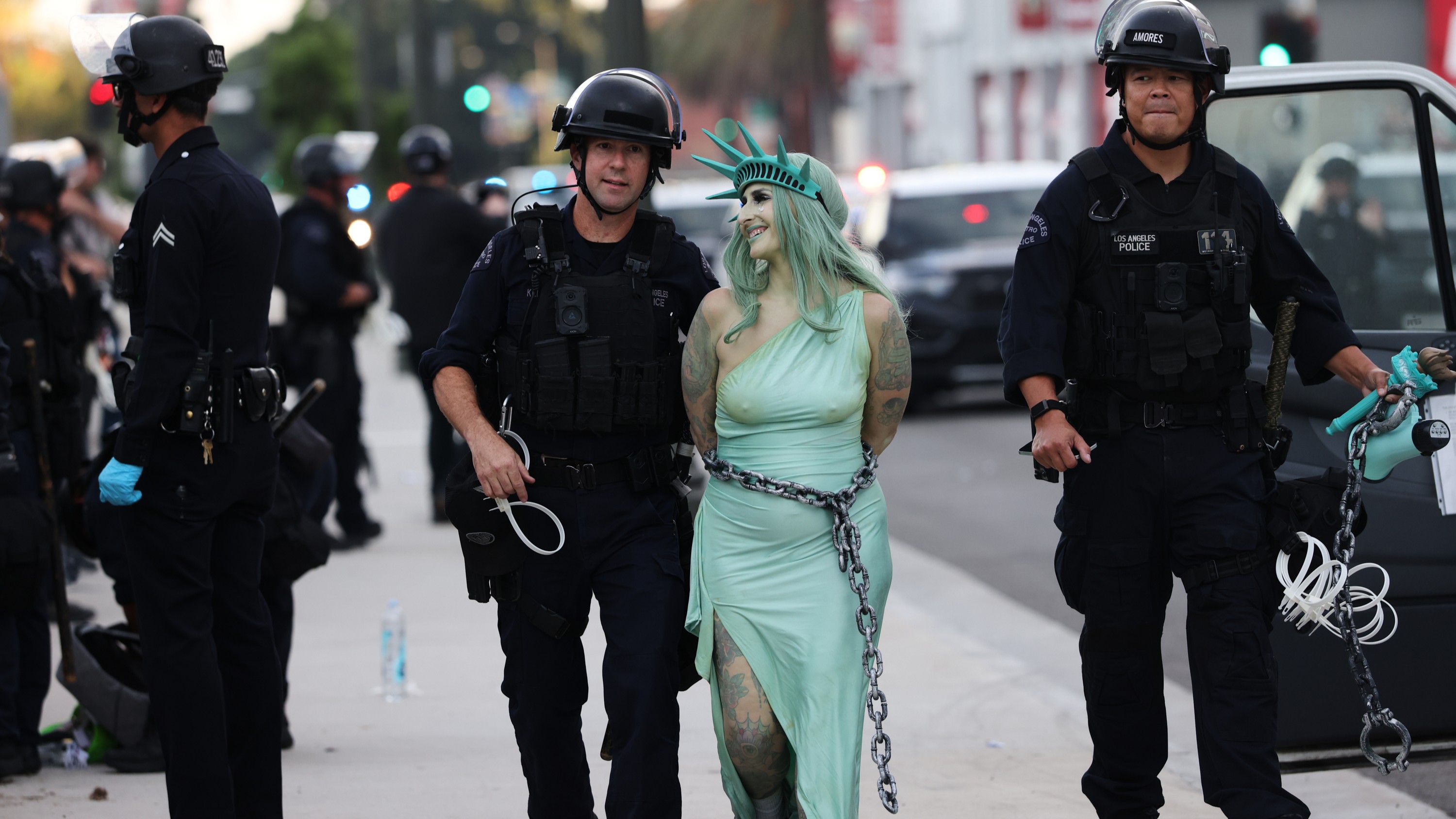 Police arrest a protestor dressed as the Statue of Liberty, in downtown Los Angeles after the "No Kings" rally Saturday, March 28, 2026.