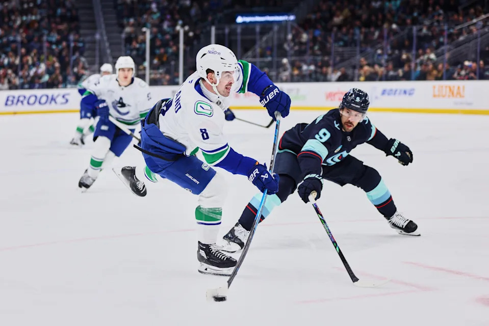 Feb 28, 2026; Seattle, Washington, USA; Vancouver Canucks right wing Conor Garland (8) takes a shot on goal during the third period against the Seattle Kraken at Climate Pledge Arena. Mandatory Credit: Blake Dahlin-Imagn Images
