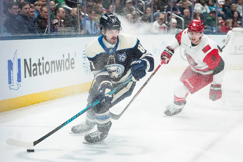 Blue Jackets right wing Conor Garland skates around Hurricanes defenseman Mike Reilly on March 17.
