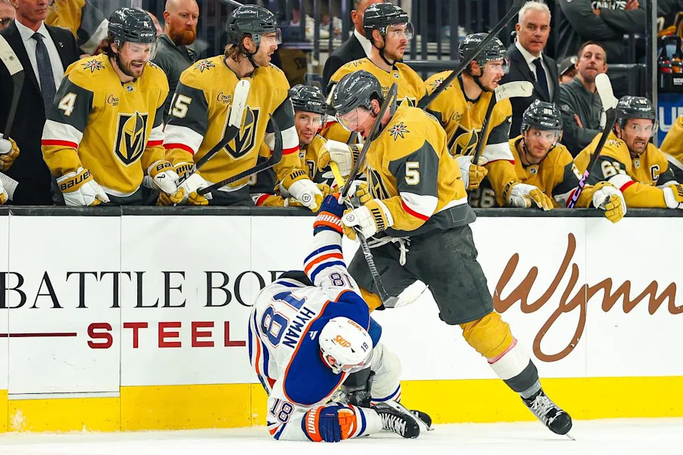 Vegas Golden Knights D Jeremy Lauzon (5) lays a hit on Edmonton Oilers F Zach Hyman (18) during an NHL game on Thursday, March 26, 2026, in Las Vegas, Nevada.