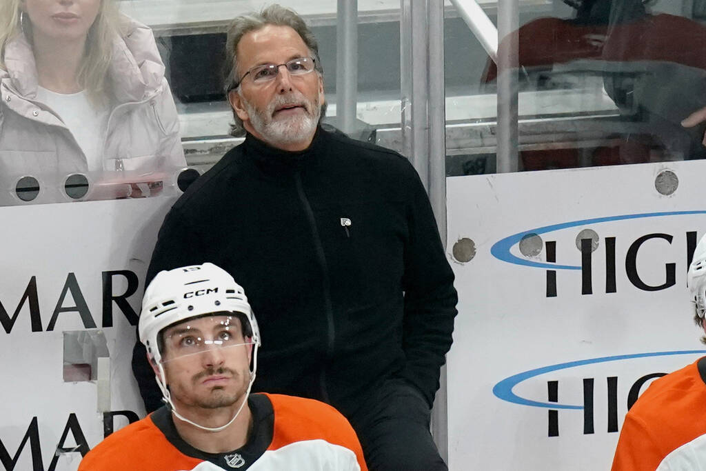 Philadelphia Flyers head coach John Tortorella stands behind his bench during the first period ...