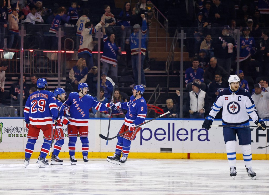 New York Rangers players celebrate a goal against the Winnipeg Jets.
