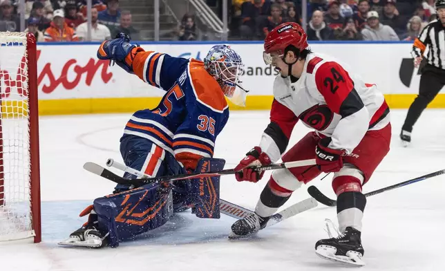 Carolina Hurricanes' Seth Jarvis (24) is stopped by Edmonton Oilers goalie Tristan Jarry (35) during the third period of an NHL game, in Edmonton on Friday, March 6, 2026. (Jason Franson/The Canadian Press via AP)