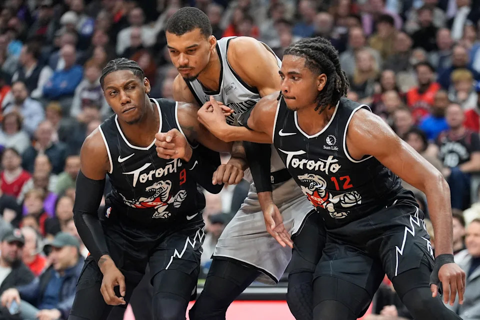 Feb 25, 2026; Toronto, Ontario, CAN; Toronto Raptors forward RJ Barrett (9) and forward Collin Murray-Boyles (12) block out San Antonio Spurs center Victor Wembanyama (1) during the first half at Scotiabank Arena. Mandatory Credit: John E. Sokolowski-Imagn Images