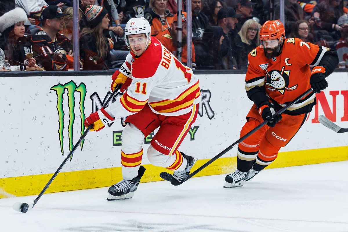 Calgary Flames center Mikael Backlund (11) skates with the puck during an NHL match against the Anaheim Ducks on March 1, 2026 in Anaheim, California.