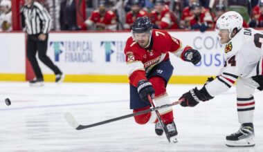 Florida Panthers defenseman Dmitry Kulikov (7) and Chicago Blackhawks center Colton Dach (34) compete for the puck in the second period of their NHL game at Amerant Bank Arena on Tuesday, Oct. 7, 2025, in Sunrise, Fla.