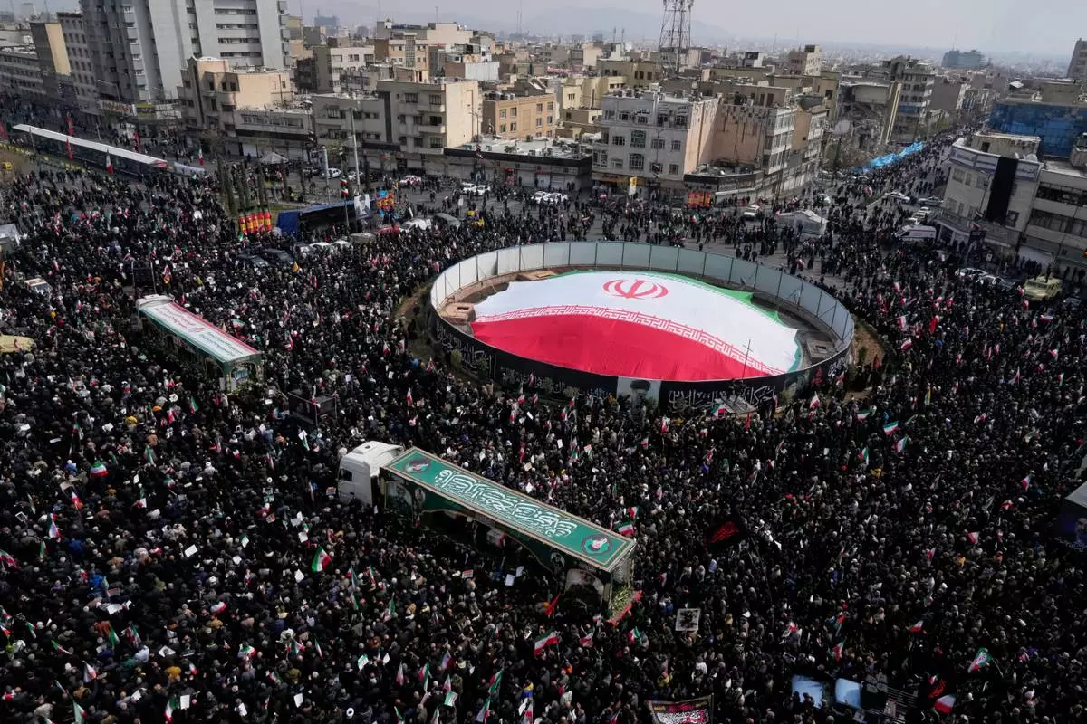 Mourners attend the funeral procession for senior Iranian military officials and some civilians killed during the U.S.-Israel campaign, in Tehran, Iran, Wednesday, March 11, 2026. (AP Photo/Vahid Salemi)