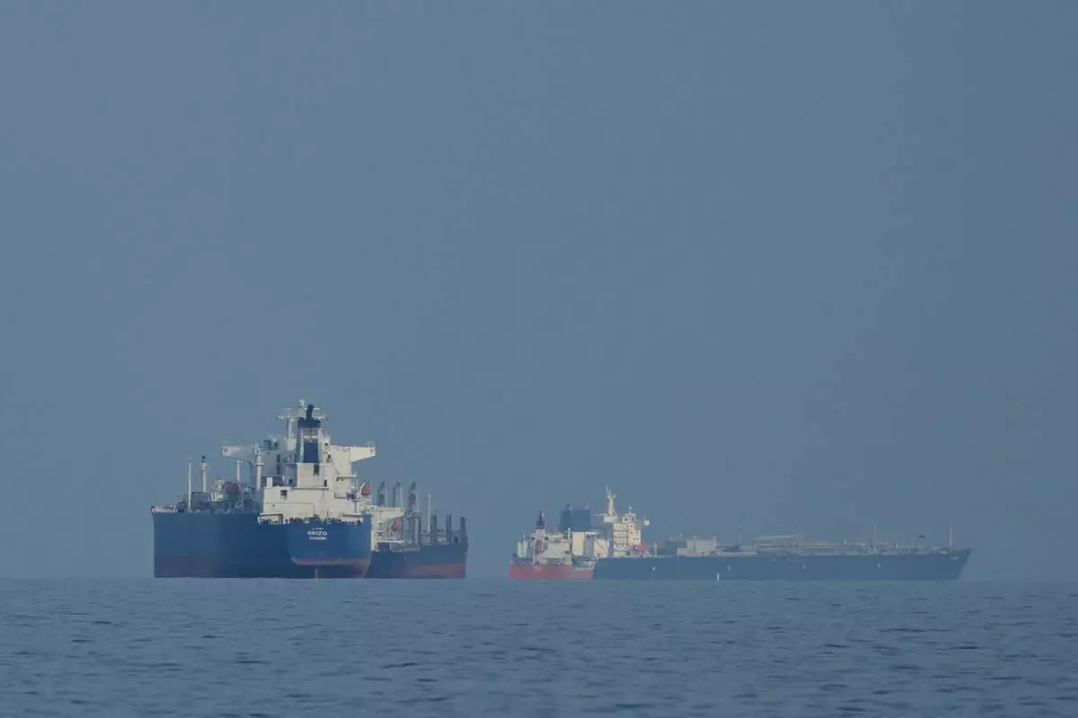 Oil tankers and cargo ships line up in the Strait of Hormuz as seen from Khor Fakkan, United Arab Emirates, Wednesday, March 11, 2026. (AP Photo/Altaf Qadri)