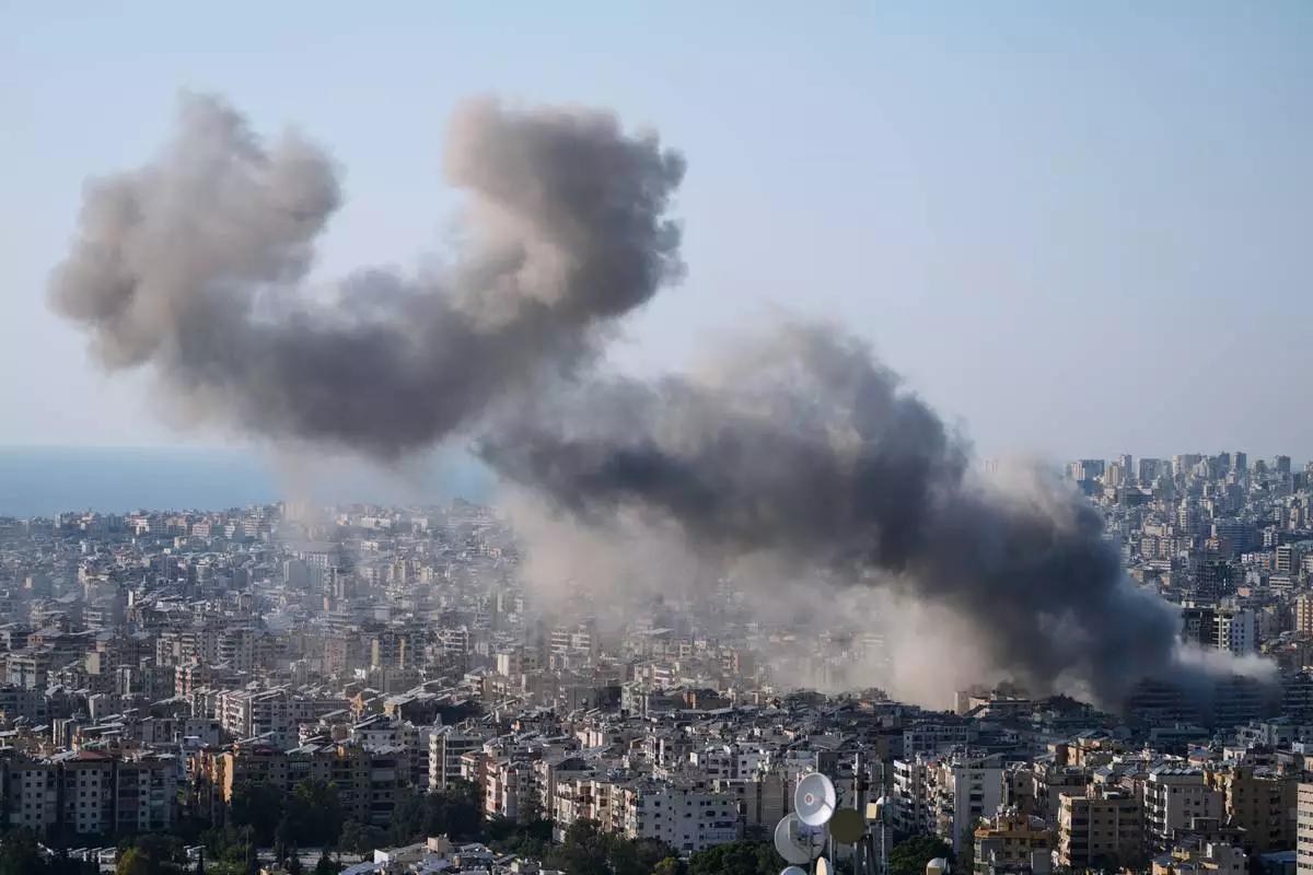 Smoke rise from an Israeli airstrike in Dahiyeh, Beirut's southern suburbs, Lebanon, Tuesday, March 10, 2026. (AP Photo/Bilal Hussein)