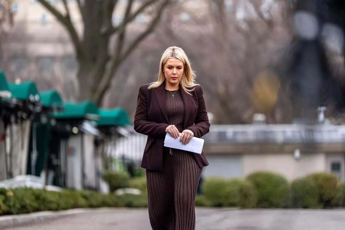 White House press secretary Karoline Leavitt walks to speak with reporters at the White House, Friday, March 6, 2026, in Washington. (AP Photo/Alex Brandon)
