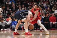 Toronto Raptors' Scottie Barnes (4) defends against Dallas Mavericks' forward Cooper Flagg...