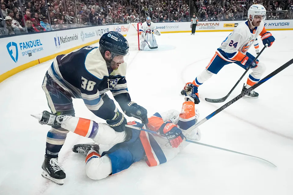 Columbus Blue Jackets center Boone Jenner (38) hits New York Islanders defenseman Adam Pelech (3) during the third period of the NHL hockey game at Nationwide Arena in Columbus on Feb. 28, 2026. The Blue Jackets lost 4-3 in overtime.