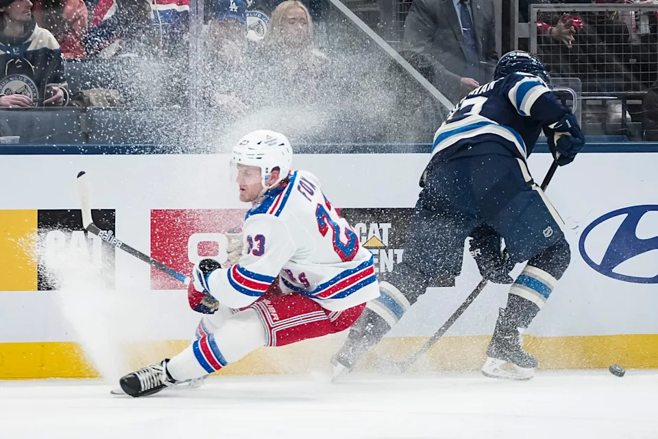 Blue Jackets center Sean Monahan skates around Rangers defenseman Adam Fox on March 19.