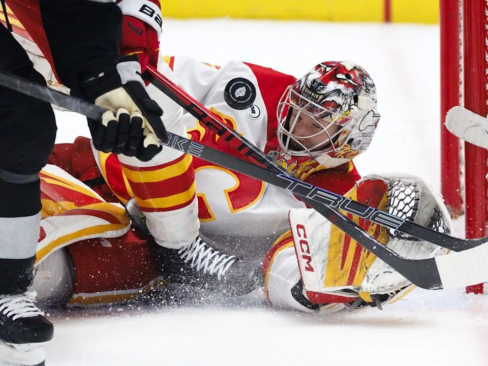  Flames goalie Dustin Wolf chases a loose puck during Saturday’s game.