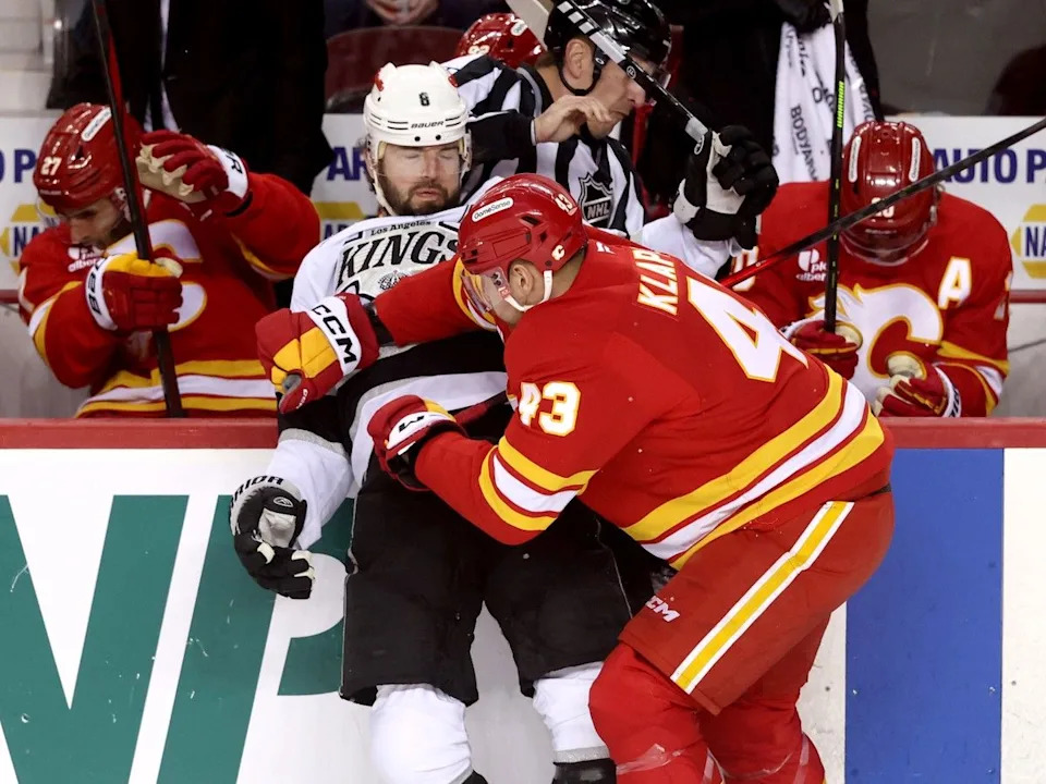  Flames forward Adam Klapka battles Drew Doughty.