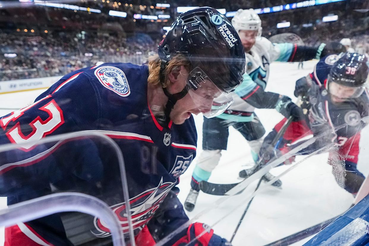 Columbus Blue Jackets left wing Danton Heinen (43) fights for the puck along the boards during the third period of the NHL hockey game against the Seattle Kraken at Nationwide Arena on March 21, 2026. The Blue Jackets won 5-2.