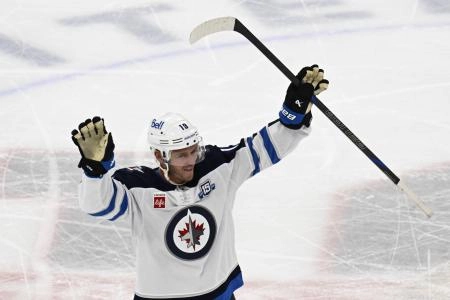 Jan 19, 2026; Chicago, Illinois, USA; Winnipeg Jets center Jonathan Toews (19) acknowledges the crowd during the first period of his first game back at the United Center since leaving the Chicago Blackhawks