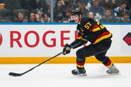 Jan 31, 2026; Vancouver, British Columbia, CAN; Vancouver Canucks defenseman Tyler Myers (57) handles the puck against the Toronto Maple Leafs in the first period at Rogers Arena.