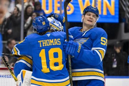 Nov 11, 2025; St. Louis, Missouri, USA; St. Louis Blues goaltender Jordan Binnington (50) center Robert Thomas (18) and defenseman Colton Parayko (55) celebrate after the Blues defeated the Calgary Flames at Enterprise Center. Mandatory Credit: Jeff Curry-Imagn Images