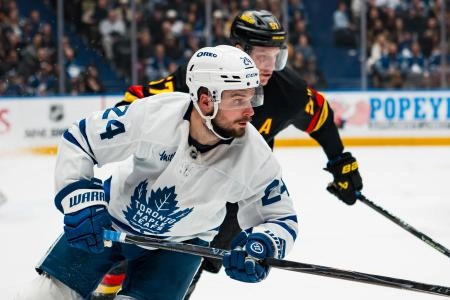 Jan 31, 2026; Vancouver, British Columbia, CAN; Vancouver Canucks defenseman Tyler Myers (57) defends against Toronto Maple Leafs forward Scott Laughton (24) in the third period at Rogers Arena