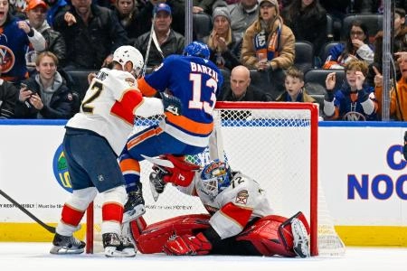 Mar 1, 2026; Elmont, New York, USA; New York Islanders center Mathew Barzal (13) hangs on to the top of the net as Florida Panthers goaltender Sergei Bobrovsky (72) makes a save during the first periodat UBS Arena.