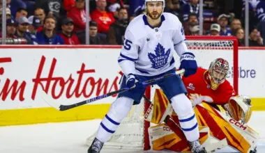 Toronto Maple Leafs center Nicolas Roy (55) screens in front of Calgary Flames goaltender Dustin Wolf (32) during the third period at Scotiabank Saddledome.