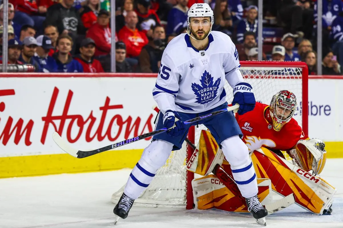 Toronto Maple Leafs center Nicolas Roy (55) screens in front of Calgary Flames goaltender Dustin Wolf (32) during the third period at Scotiabank Saddledome.