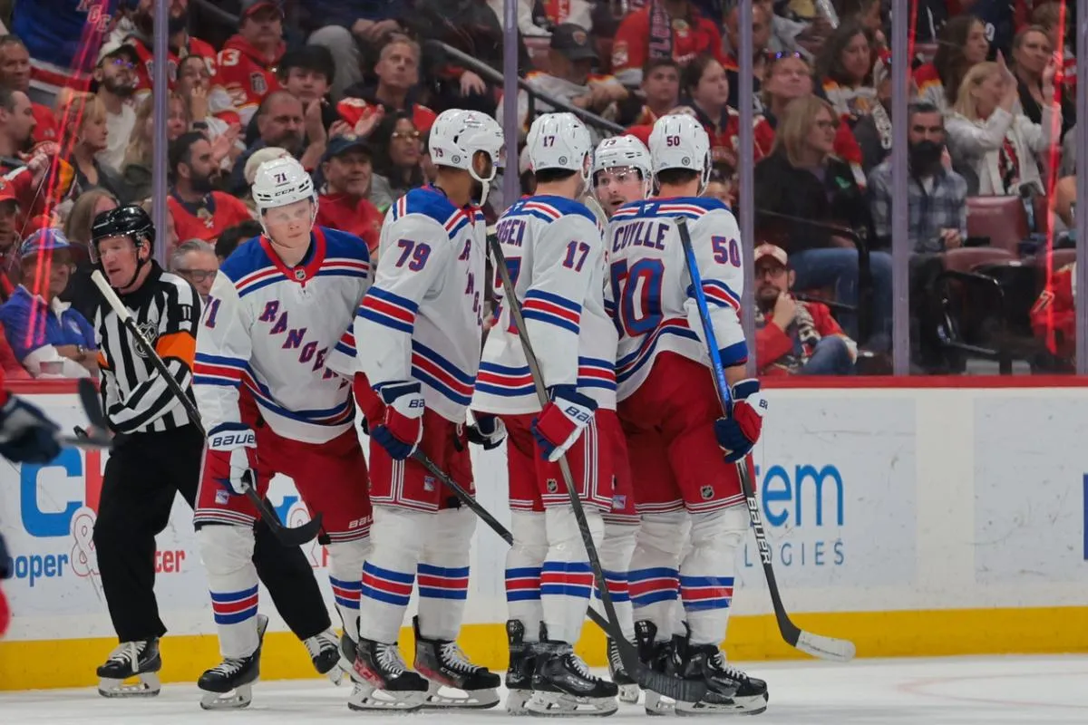 New York Rangers center Juuso Parssinen (71) celebrates with teammates after scoring against the Florida Panthers during the second period at Amerant Bank Arena.